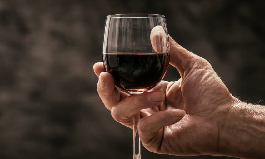Man tasting a glass of red wine